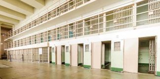 Prison Hormones Cut Off — Lawsuits Loading Interior view of a prison cell block with empty cells and security bars