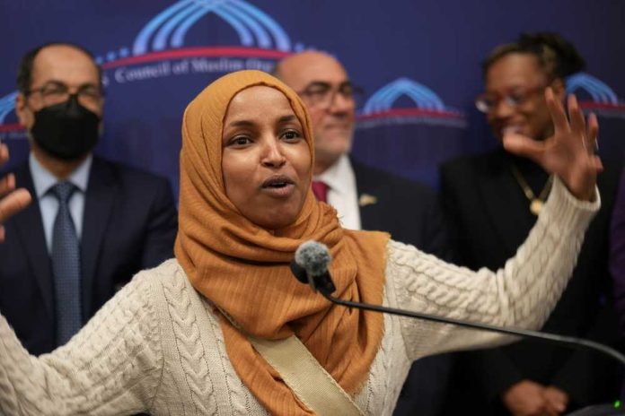 shutterstock_2622593743 A woman in a hijab passionately speaking at a podium with a diverse group in the background