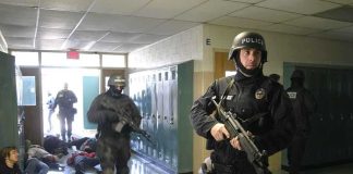 Bathroom Bombing Warning Leads to Federal Arrest Police officers responding to a school emergency with students on the floor