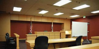 DNA Trap Nails Fresno Predator Interior view of an empty courtroom with wooden furniture and American flags