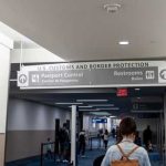 Woman walking towards US customs and passport control