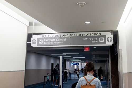 us-airport-immigration-check2251661597jpg Woman walking towards US customs and passport control