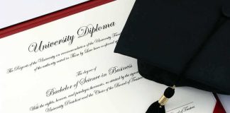 Graduation cap and diploma on a red folder