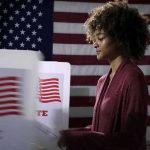 Trump-Backed Darline Graham Advances to South Carolina Senate Runoff Voter at a polling booth with an American flag backdrop