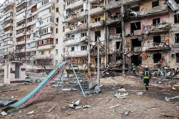 Damaged apartment building behind a playground slide