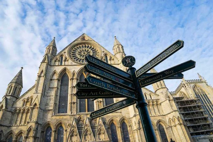 Gothic cathedral with ornate facade and directional signpost in foreground