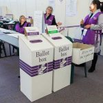 MSNBC Stunned as Late Ballot Drop Sinks Democrat Socialist Election workers near ballot boxes in a polling station