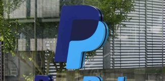 PayPal Could Be Sold to Stripe in $50 Billion-Plus Deal PayPal logo on a glass building facade