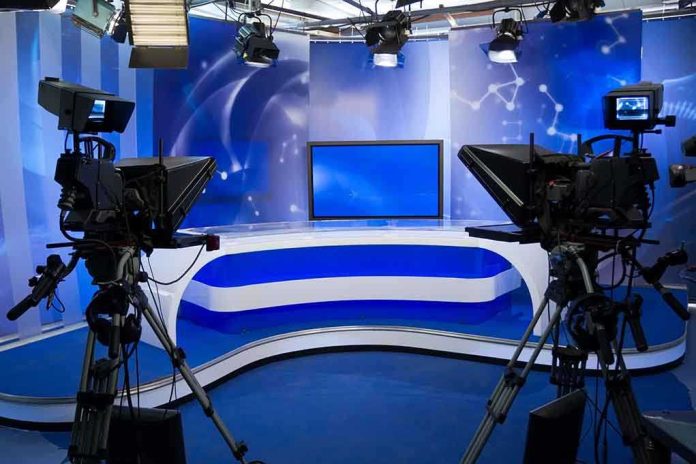 shutterstock_94783030 A television studio setup with cameras and a blue backdrop