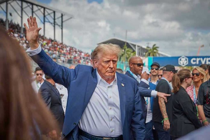 2458373881 Donald Trump waving while walking through a crowded outdoor event