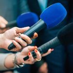 Air Force One Mishap DELAYS Trump’s Departure Reporters holding colorful microphones