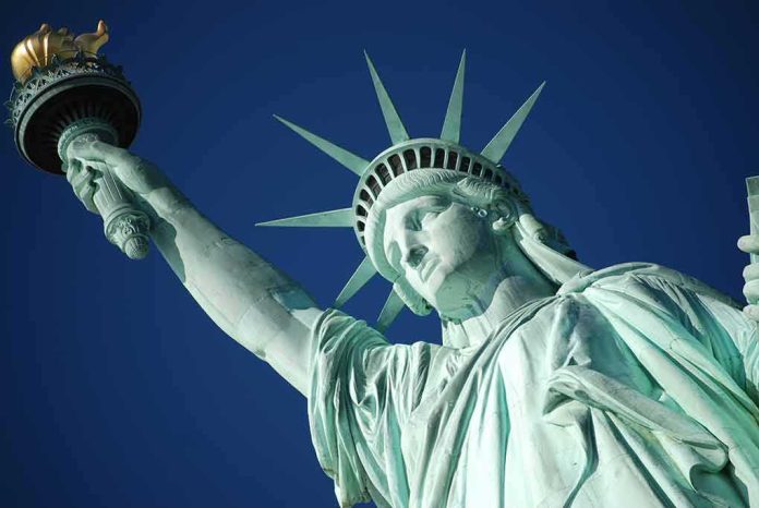 Statue of Liberty holding torch against clear blue sky