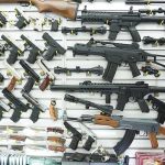 Wall display of assorted firearms in a gun shop
