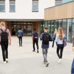 IRS Threat Puts Elite Schools On Notice Students with backpacks walking toward a school entrance