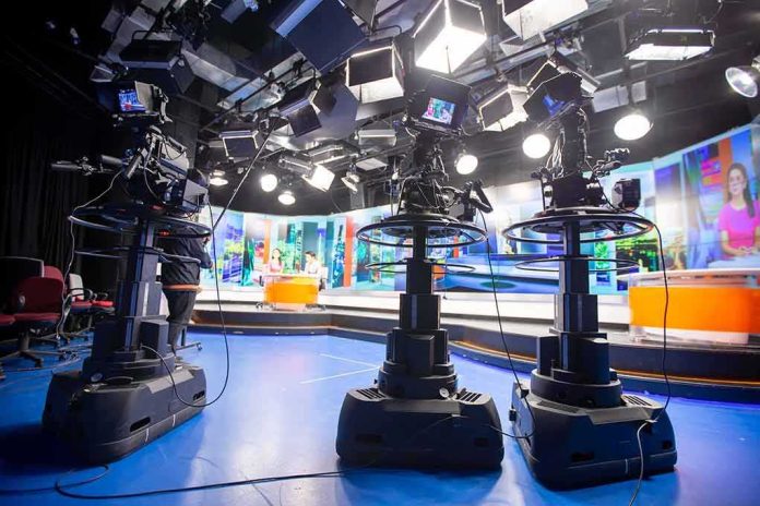 television studio with cameras on pedestals facing news desk