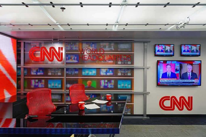 shutterstock_1284301780 CNN newsroom set with red chairs and multiple TVs