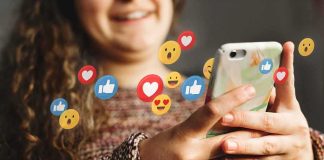 Person using smartphone with social media reaction icons floating around