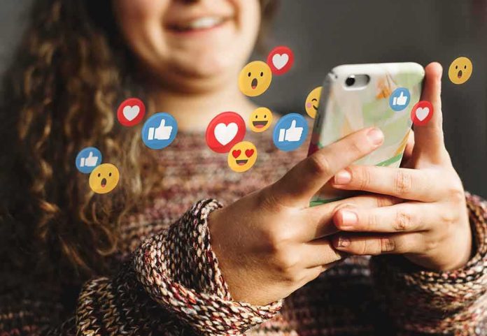 Person using smartphone with social media reaction icons floating around