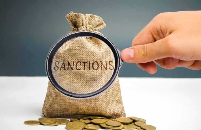 shutterstock_1341325112 hand holding magnifying glass over burlap money bag with coins