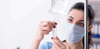 Healthcare worker adjusting IV drip line