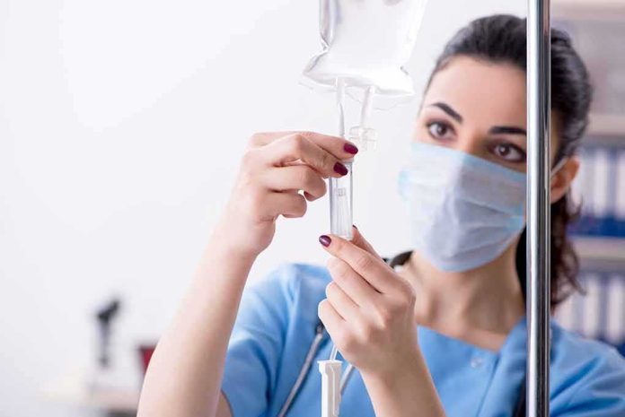 Healthcare worker adjusting IV drip line