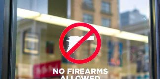 No firearms allowed sign on a store window