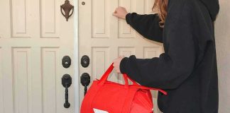Food delivery worker knocking on a front door with a red insulated bag