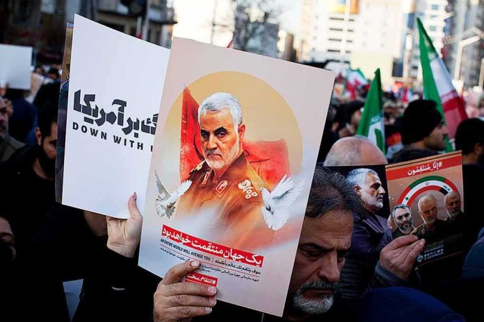 shutterstock_1609269847 Protesters holding posters of Qasem Soleimani and Abu Mahdi al-Muhandis