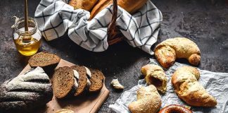 Assorted breads and pastries on a dark rustic surface