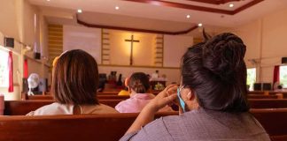 James Talarico’s Pastor DENIES Jesus Died For Sins people seated in church pews facing a cross