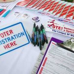 Talarico Voted From Parents’ House in Five Elections Voter registration table with forms, pens, and informational materials