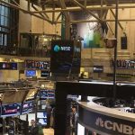 NYSE trading floor with monitors and tickers