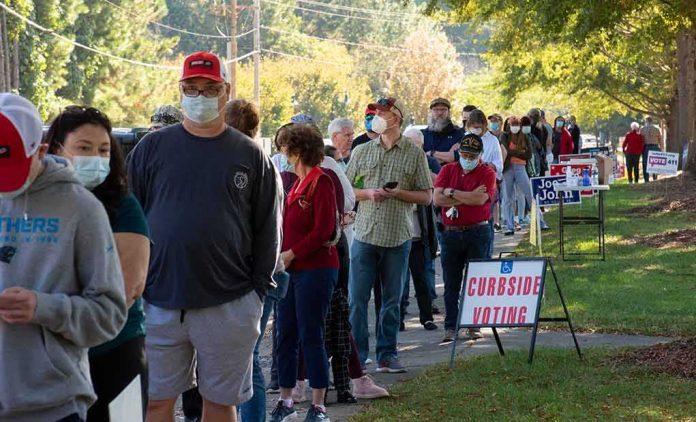 Christian Jones and others waiting in a long line outside a polling place