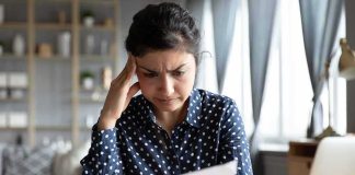 Woman reading a document with a worried expression