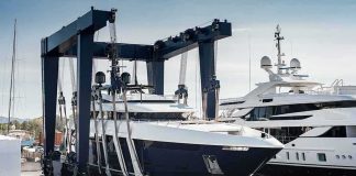 Superyacht being lifted by a travel lift at a marina