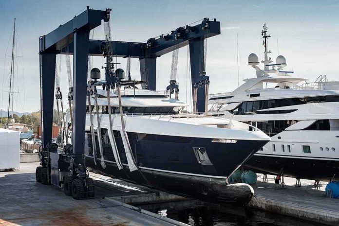 Superyacht being lifted by a travel lift at a marina