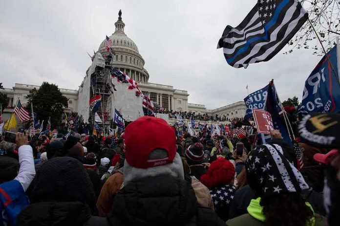 Crowd gathers outside the United States Capitol with numerous flags