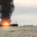 Houthi Missile Barrage Sets Yemen’s Mocha Port Ablaze Cargo ship on fire with thick black smoke at sea