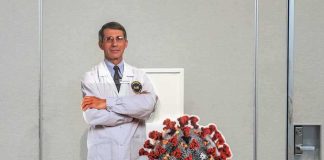 White House Backs Anti-Vax Crowd? Cardboard cutout of doctor with COVID-19 virus info display
