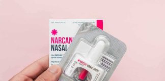 Narcan nasal spray in blister pack held by hand