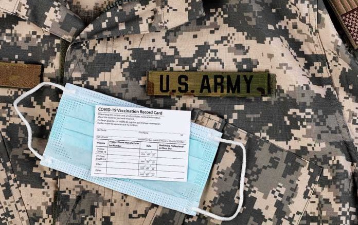shutterstock_1969700104 U.S. Army uniform with face mask and vaccination card