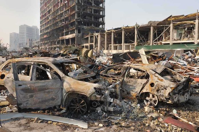 shutterstock_2140835367 Burned cars amid rubble in a destroyed urban area