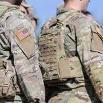 Terror Arrests Rock Base Used by U.S. Forces U.S. soldiers in camouflage uniforms with tactical vests