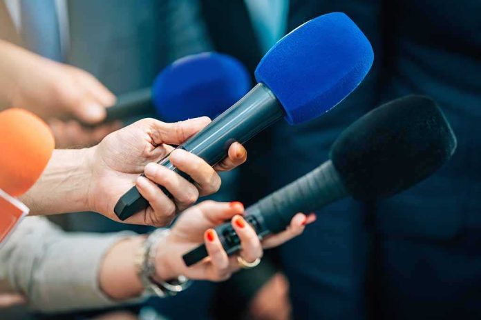 shutterstock_2168392339-3 Reporters holding colorful microphones