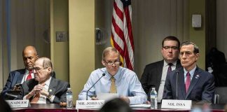 Jim Jordan speaks at a committee hearing with Jerrold Nadler and Darrell Issa seated beside him