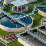 Wastewater treatment plant with circular clarifiers and aeration tanks