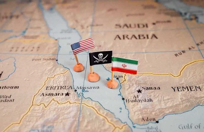 shutterstock_2411562673 Map with US, pirate, and Iran flags near the Red Sea