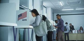 Voters at polling booths in a modern voting center