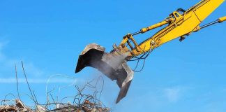Excavator arm sorting rubble and rebar