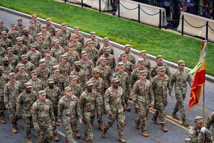 shutterstock_2641594415 Soldiers in camouflage uniforms march in formation on a street